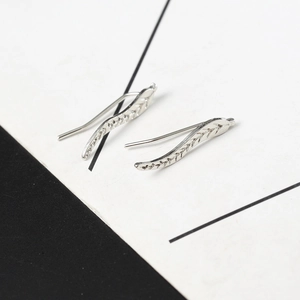 Macro shot of silver leaf ear climber earrings showing detailed metallic texture