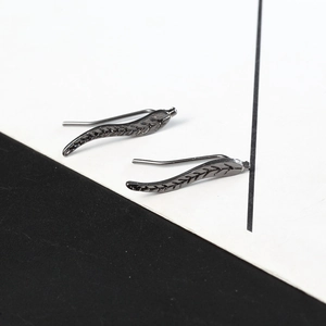 Detailed view of gunmetal leaf-shaped ear climbers with realistic leaf vein texture