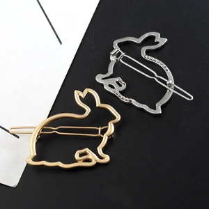 Close-up detail of hollow rabbit hair clip in polished gold and silver metal finishes
