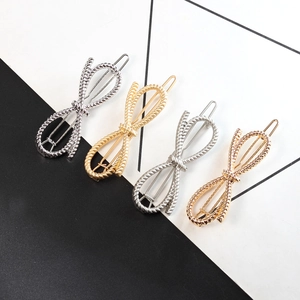 Elegant metallic bow hair clips in gold, silver, and rose gold with twisted rope texture