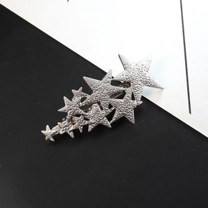 Silver hammered star hair clip with multiple stars and metallic alligator base for styling