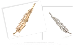 Detail shot of leaf-shaped gold and silver alloy hairpins with intricate metal textures