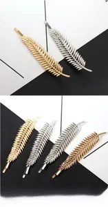 Macro detail of leaf-shaped zinc alloy hair clips in gold, silver and rose gold colors