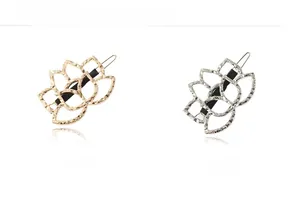 Detailed close-up of hollow lotus flower hair clips in gold and silver plating