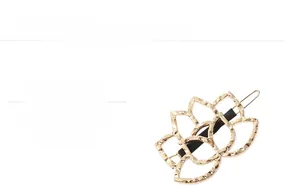 Detailed close-up of a gold hollow geometric flower hair clip with mirror polished finish