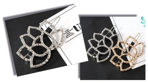 Macro detail of hollow lotus flower hair clip with textured metallic finish in gold and silver