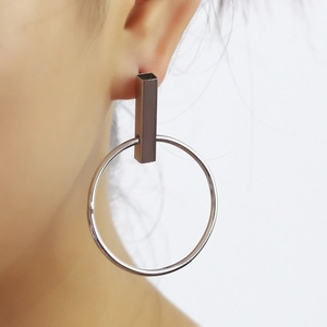 Gros plan de boucles d'oreilles minimalistes en métal argenté avec design rectangulaire