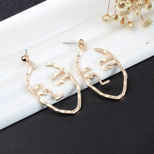 Minimalist gold abstract face outline earrings in artistic hollow metal design