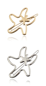 Detailed view of hollow starfish hair clips in gold and silver finishes on white background