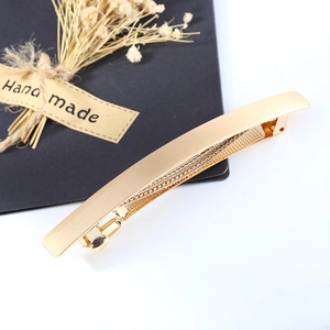 Matte gold alloy rectangular hair clip with slim curved design on a white background