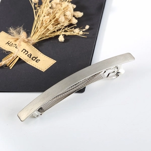 Detail view of silver brushed alloy hair clip with elegant handmade card and dried flowers