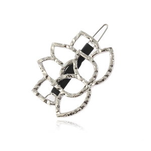 Silver textured lotus flower hair clip with vintage hammered finish on white background