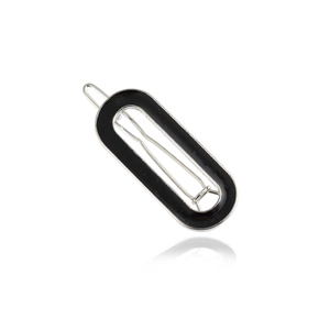 Minimalist oval black enamel hair clip with silver metal frame and elegant mirror reflection