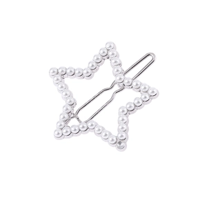 Detail view of a silver star-shaped hair clip with inlaid pearls on a white background