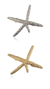 Detailed view of starfish hair clips in gold and silver with textured metal surface