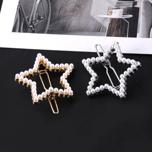 Detailed close-up of hollow star hair clips with white pearls in gold and silver metal finish