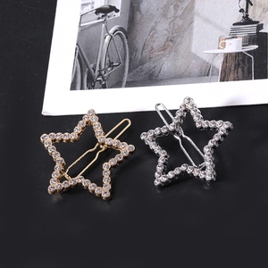 Detail view of gold and silver hollow star hair clips with micro-pave rhinestones