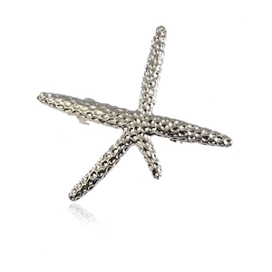 Chic starfish hair clip with silver textured hammered finish on a white reflective base