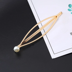 Minimalist gold leaf-shaped metal hair clip with a single pearl accent for women