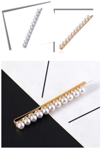 Detail showing elegant pearl barrette with gold and silver alloy base for women's hair styling