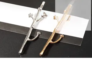 Detailed close-up of gold and silver flower tree branch hair clips with textured finish