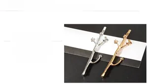 Detail showing polished gold and silver branch hair clips with small flower accents