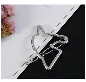 Close-up of a silver polished hollow animal head hair clip with a wave-style metal pin