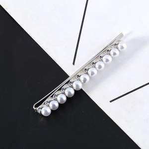Minimalist silver bobby pin hair clip with 11 white round pearls on a black-white background