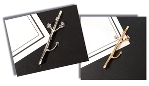 Detail of tree branch hair clips in polished gold and silver finish with flower buds