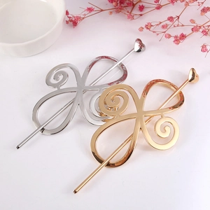 Detailed close-up of hollow alloy hairpins in gold and silver with elegant spiral design