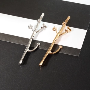 Creative flower branch hair pins in gold and silver finish with textured relief detail