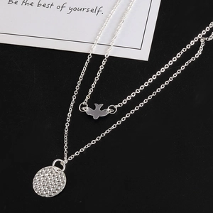 Double-layered silver necklace for women featuring bird and hammered round pendants