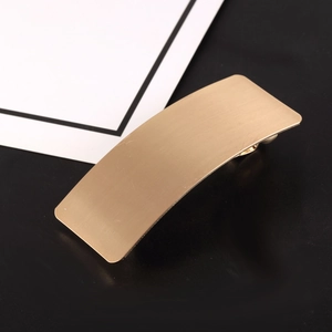 Minimalist matte gold metal hair clip with rectangular brushed texture finish