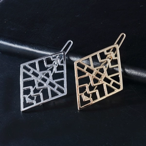 Gold and silver hollow diamond-shaped hair clips with geometric pattern on leather