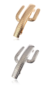 Detailed macro view of gold and silver cactus metal hair clips with wavy texture