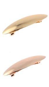 Polished gold and rose gold metal hair clips showing smooth mirror finish texture