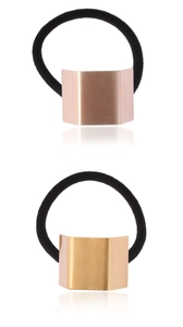 Detail of minimalist geometric metal hair ties in brushed gold and rose gold finishes