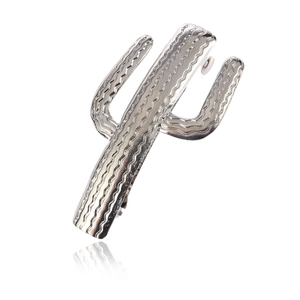 Silver cactus shaped metal hair clip with textured wavy finish on white background