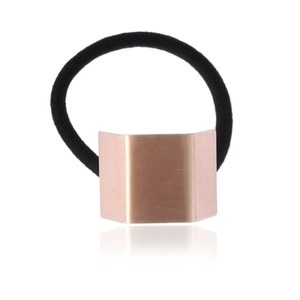 Minimalist elastic hair tie with rose gold trapezoid metal plate on white background