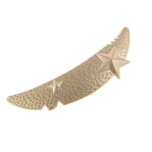 Macro detail of matte gold crescent moon hair clip with textured surface and stars