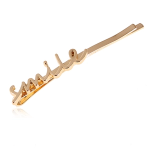 Barrette à cheveux dorée minimaliste avec motif smile et finition métallique polie
