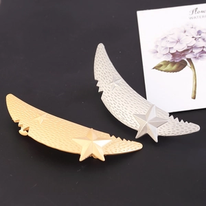 Matte gold and silver crescent moon hair clips with textured finish and star details