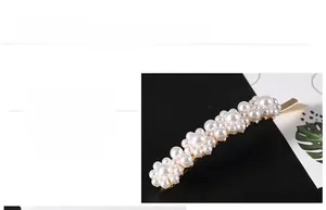 Detailed macro view of clustered pearls hair clip with polished gold alloy base
