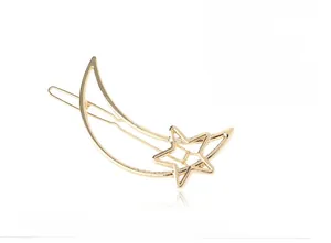 Detailed view of fashion moon and star hair clip in glossy gold alloy finish