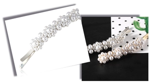 Detailed macro view of elegant wave pearl hairpins with gold and silver metal bases