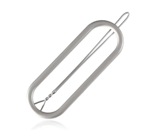 Macro detail of oval matte silver hollow hair clip with reinforced spring mechanism