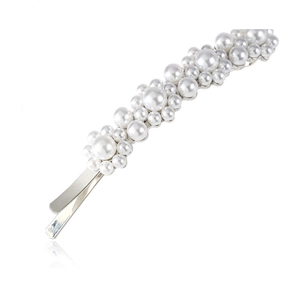 Macro detail of elegant cluster pearl hair clip with silver metal base on white background