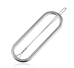 Detailed view of minimalist oval cutout hair clip in a polished silver metallic finish