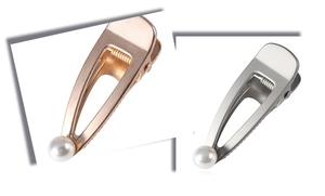 Detailed macro view of matte finish metal hair clips with elegant pearl embellishment