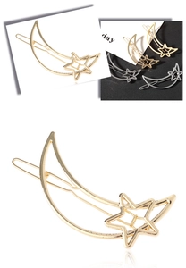 Detail of hollow moon and star metal hair clips in polished gold and silver finishes